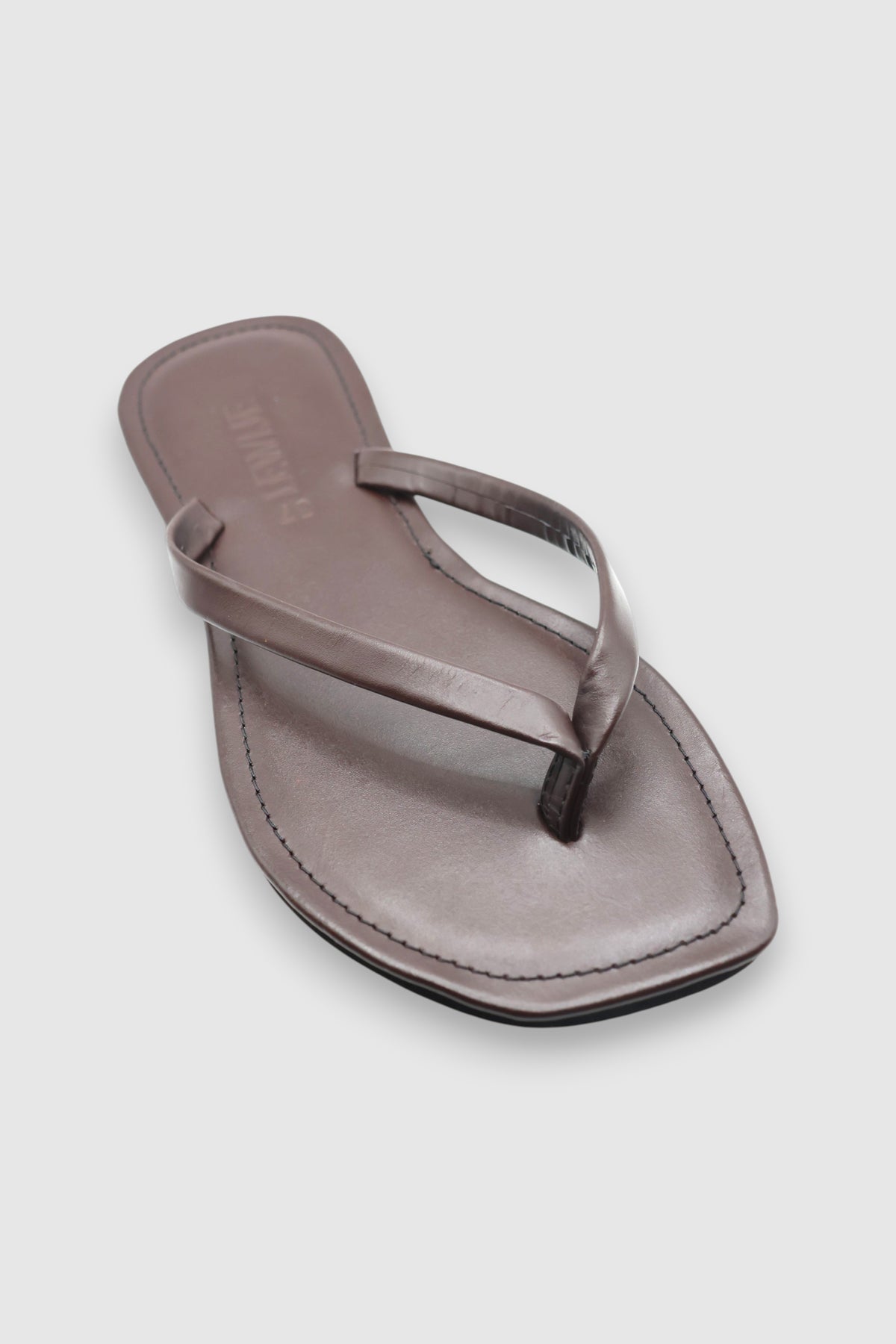 LEWIJE Mirissa flip flop in espresso brown, single sandal in three-quarter view showing the thong strap and debossed LEWIJE footbed