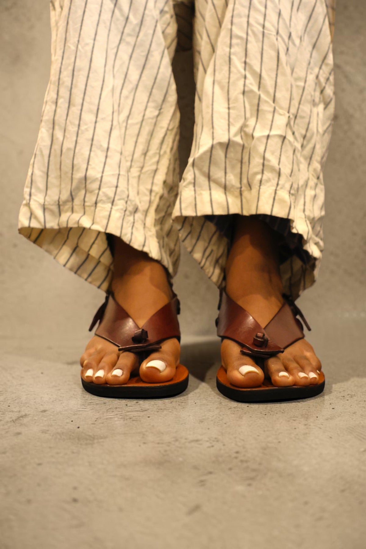 LEWIJE Serendib in brown, worn with striped linen trousers, front view