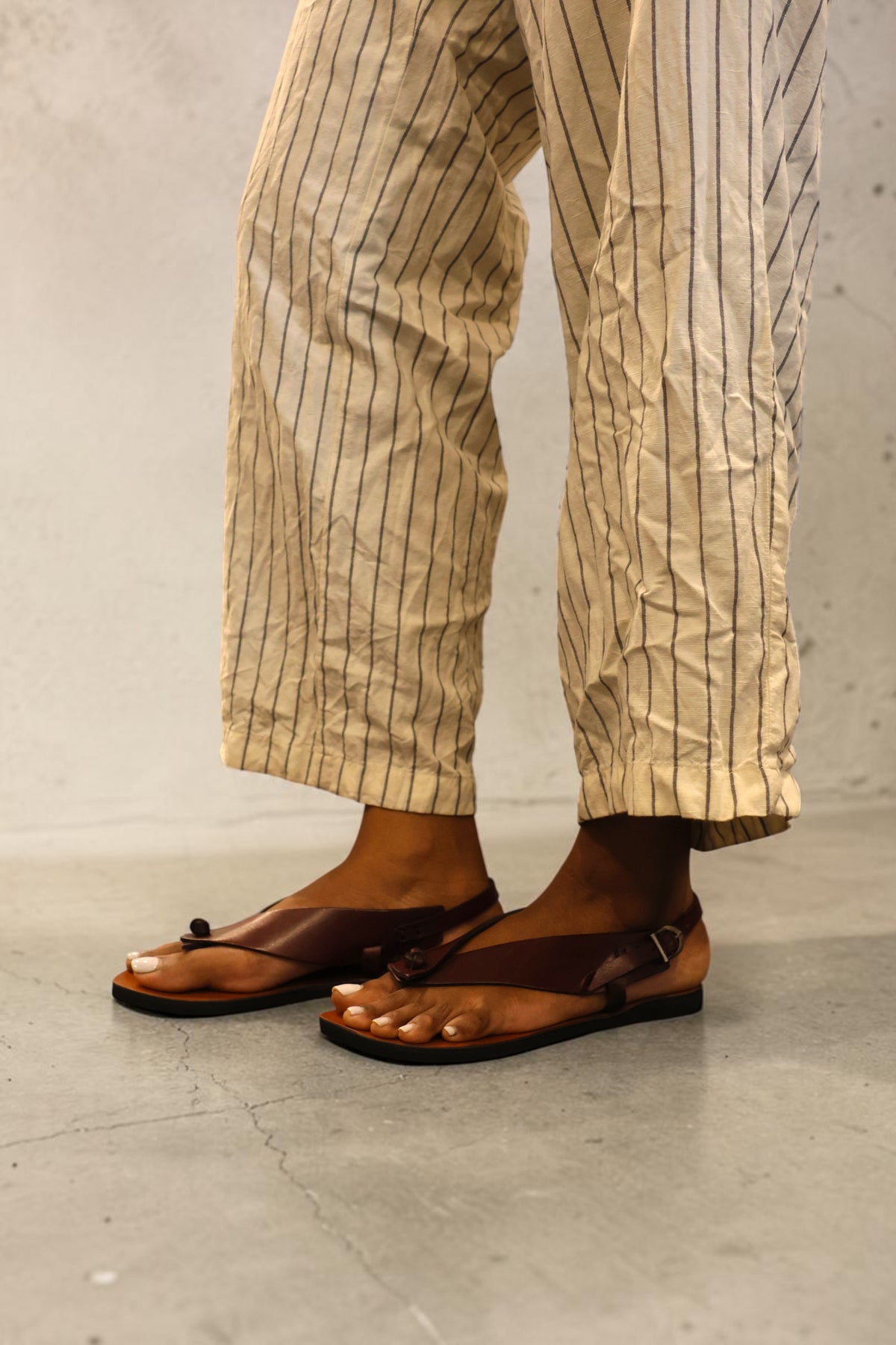 LEWIJE Serendib in brown, worn with striped linen trousers, angled view